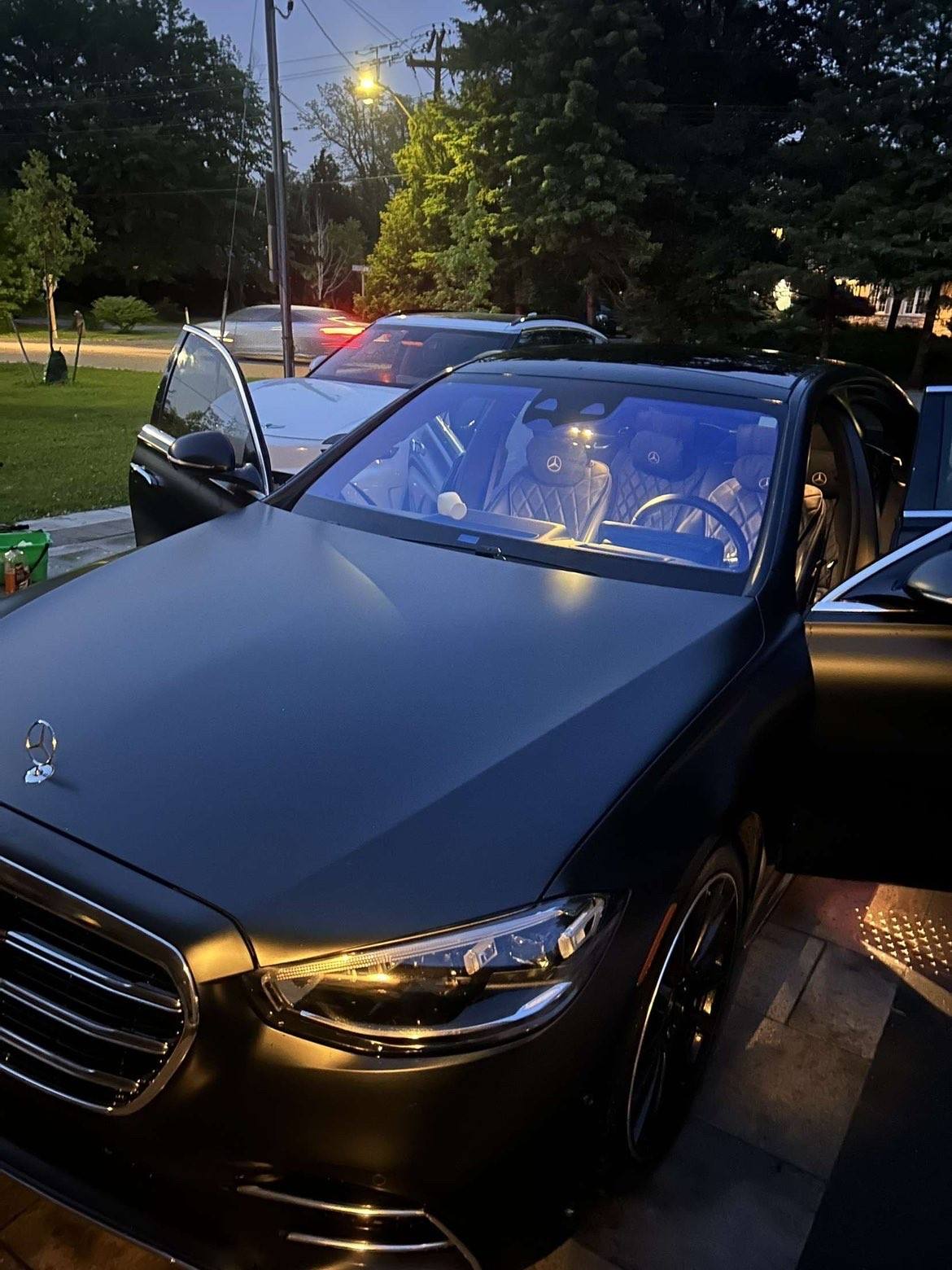 The same S-Class from the front corner, its quilted leather seats lit inside
