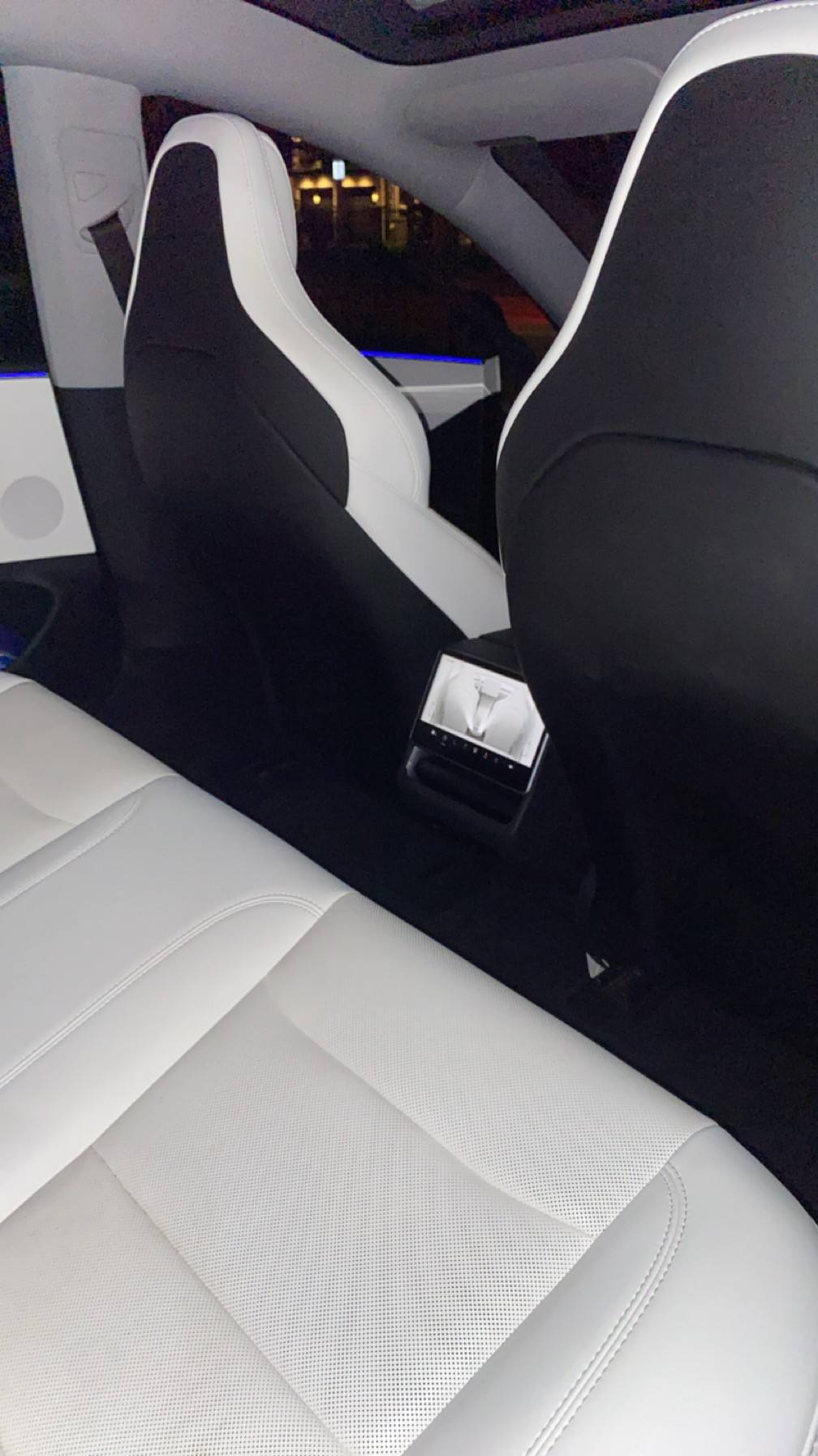 White rear seats of the same Tesla after the detail