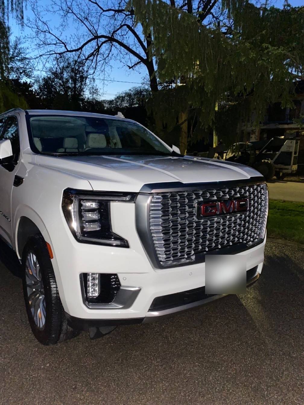 White GMC Yukon Denali from the front corner after an exterior detail